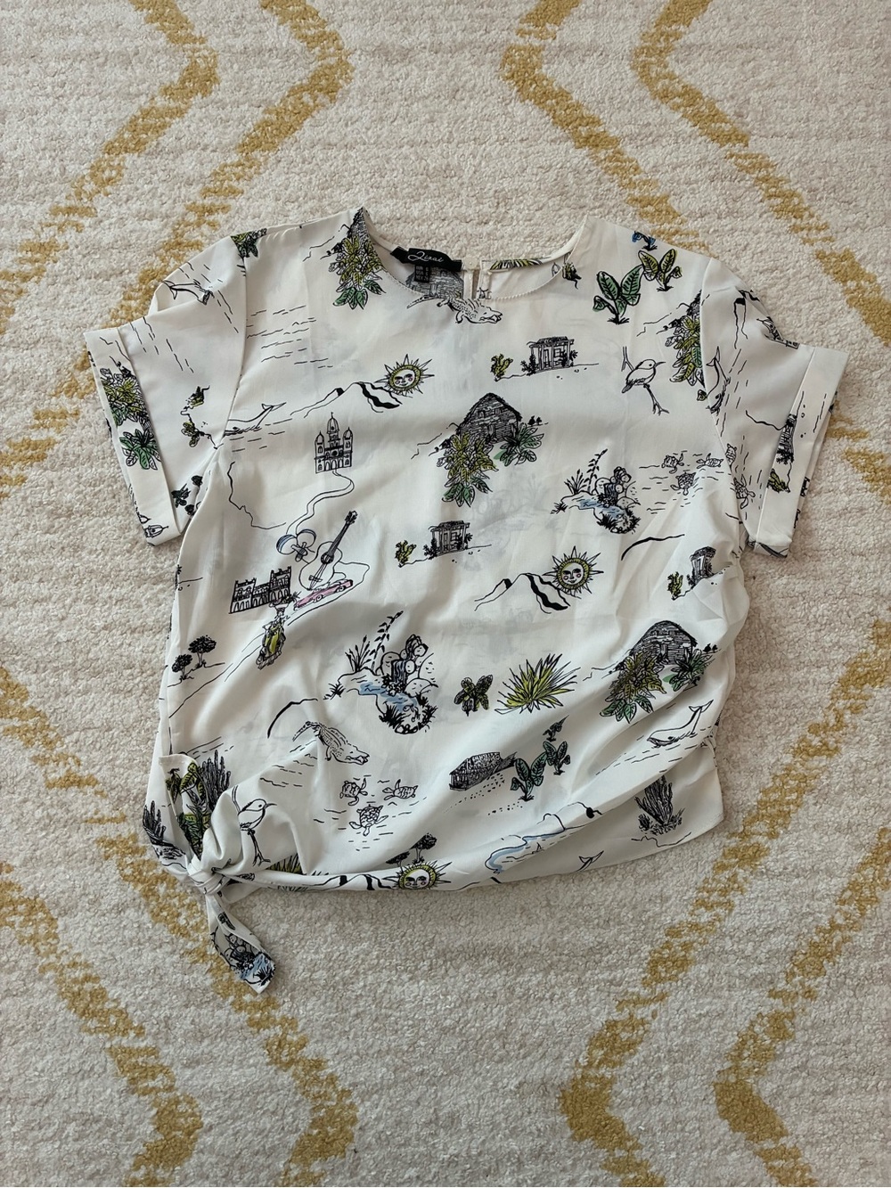 Travel themed tie waist blouse